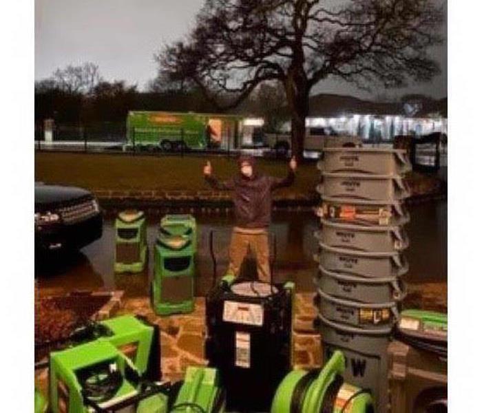 SERVPRO technician disinfecting all the equipment after being done with a water loss job in Texas
